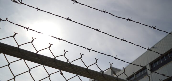 barbed wire chain link fence prison 960248